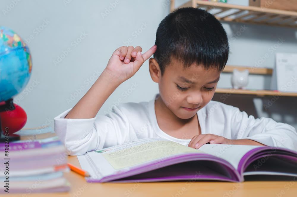Education concept, Sad tired frustrated boy sitting at the table with many books, Bored and tired boy doing homework on desk in his room, Learning difficulties. Education concept, Sad tired frustrated boy sitting at the table with many books, Bored and tired boy doing homework on desk in his room, Learning difficulties.