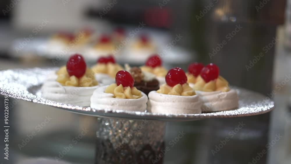 Sweet meringue decorated with confined cherry, wedding dessert course menu Sweet meringue decorated with confined cherry, wedding dessert course menu