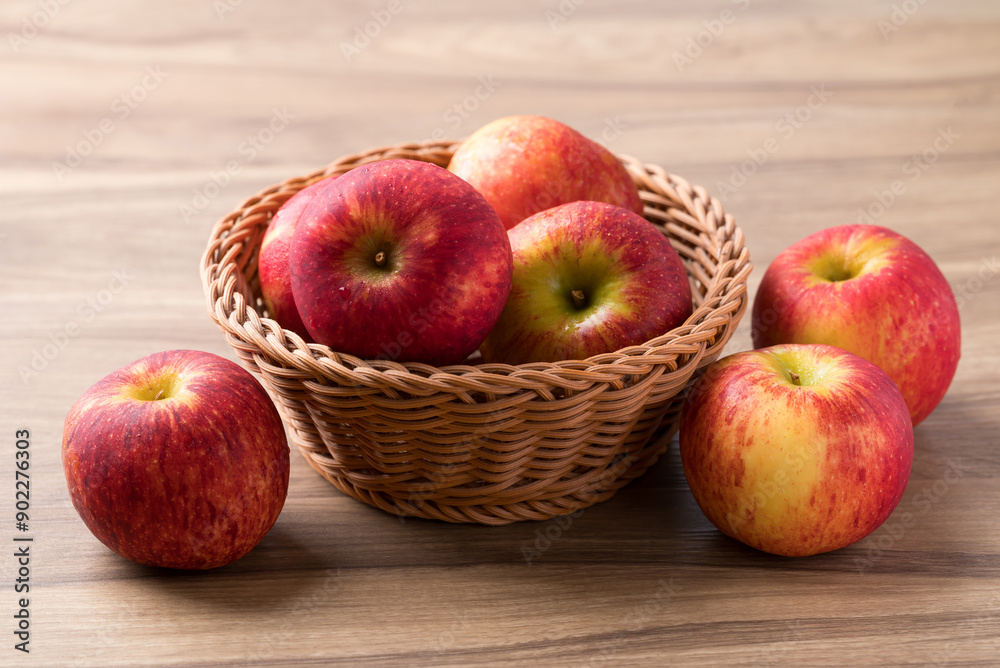 Red apple fruit (Envy apple) in basket on wooden background Red apple fruit (Envy apple) in basket on wooden background