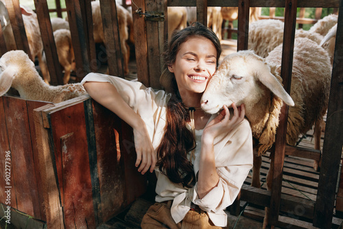 Foto A woman is petting a sheep in a barn with other sheep in the background