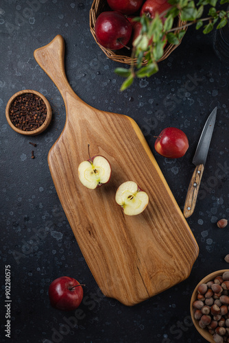 The apple is lying on a wooden chopping board photo