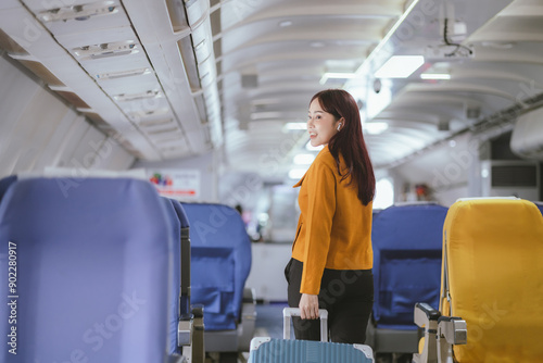 A beautiful young woman at the airport is excitedly boarding the plane with her suitcase and backpack. Her photos convey the joy of traveling.