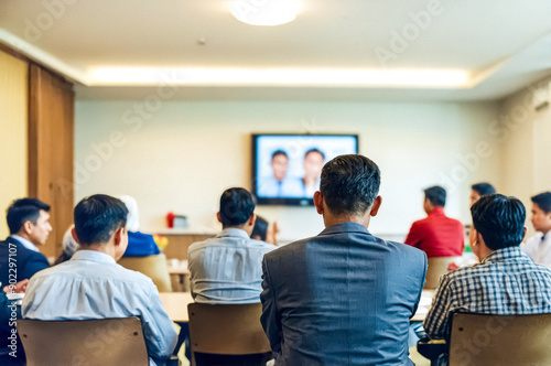 Back view of a businessman in a suit during a corporate video call