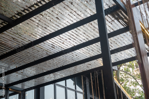 The terrace roof of the house is made of clear or transparent material and hollow iron