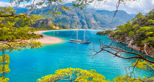 Fototapeta Naklejka Na Ścianę i Meble -  Blue gulet anchored at the Aegean sea - Panoramic view of Oludeniz Beach And Blue Lagoon, Oludeniz beach is best beaches in Turkey - Fethiye, Turkey