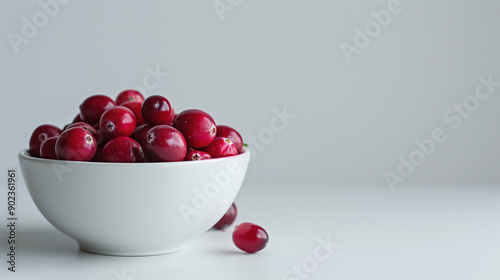 High-Quality Advertisement Image of Fresh Cranberries in Mid-Air Over White Porcelain Bowl Background photo