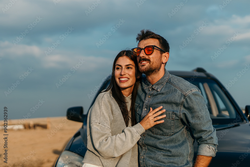 Shot of an embraced couple stopping to look at the view while on a road trip. Shot of an embraced couple stopping to look at the view while on a road trip.