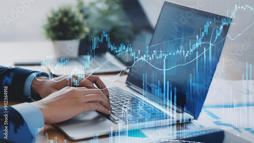  A business man looking at laptop screen with chart and graphs. The laptop screen is showing the stock market.