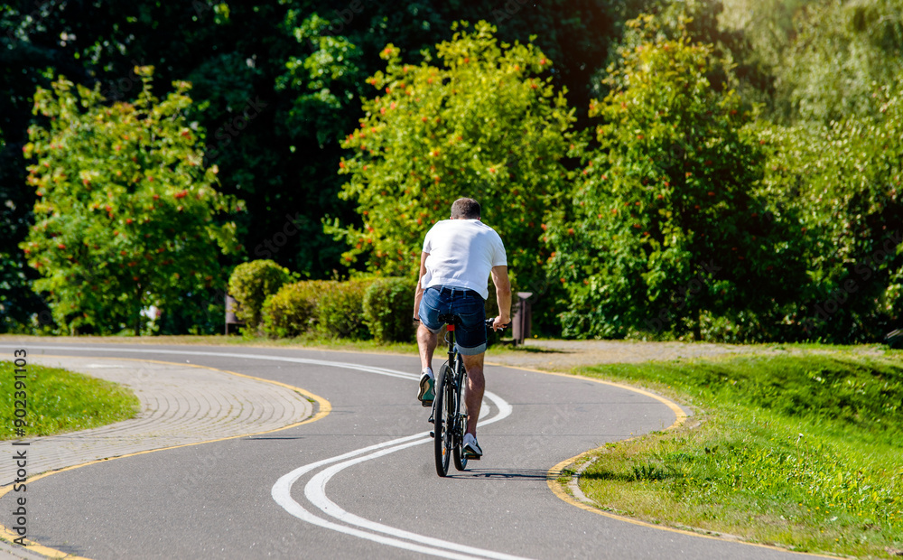 Fototapeta premium Cyclist ride on the bike path in the city Park 