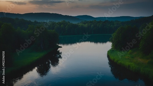 The lake’s serene waters showcasing the gentle hues of a summer twilight