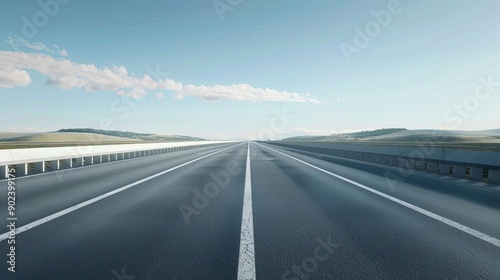 A long, empty highway stretching into the distance under a clear blue sky, representing travel, freedom, and the open road.