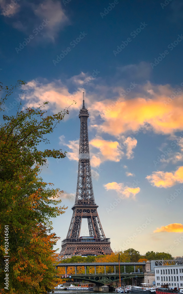 Fototapeta premium Paris with Eiffel Tower iconic Paris landmark across the River Seine with tourist boat in Autumn tree fall scene at Paris ,France