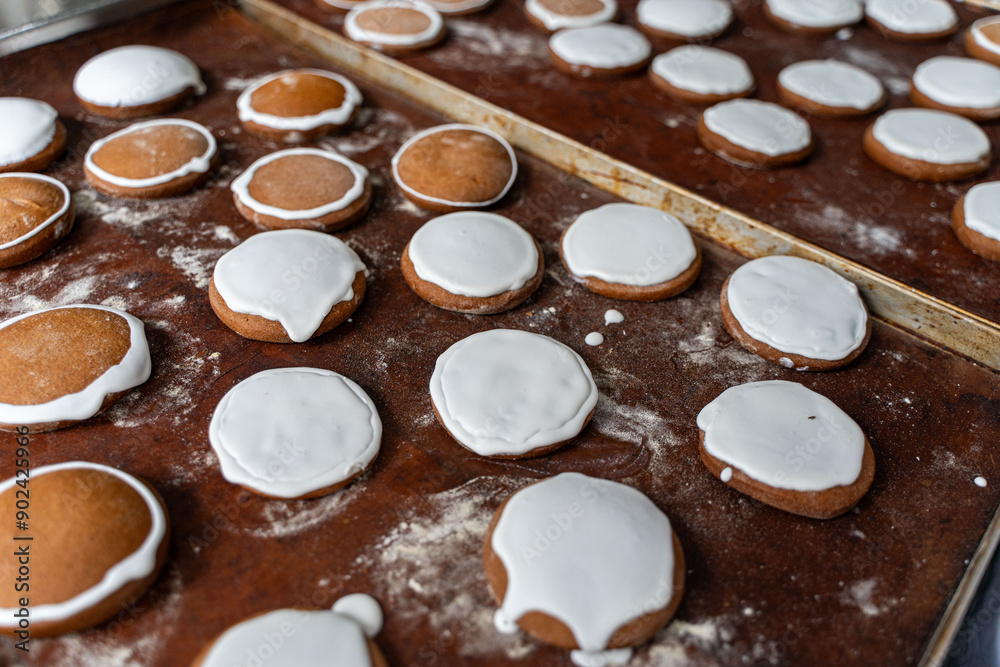 Gingerbread cookies covered with white icing on the table are ready to decorate. A small confectionery shop, handmade, home bakery. Gingerbread cookies covered with white icing on the table are ready to decorate. A small confectionery shop, handmade, home bakery.