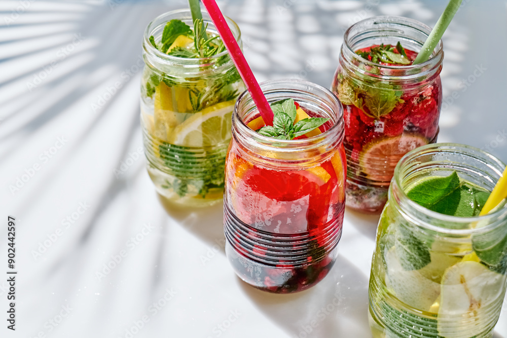 Detox drink. Different varieties of infused water with lemon, berries and herbs. Refreshing summer homemade cocktail. Fresh healthy cold beverage. Detox drink. Different varieties of infused water with lemon, berries and herbs. Refreshing summer homemade cocktail. Fresh healthy cold beverage.