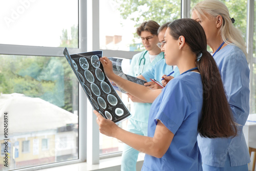 Female doctors studying MRI scan in clinic