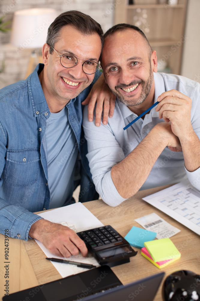 happy gay couple reading mail and checking accountancy happy gay couple reading mail and checking accountancy