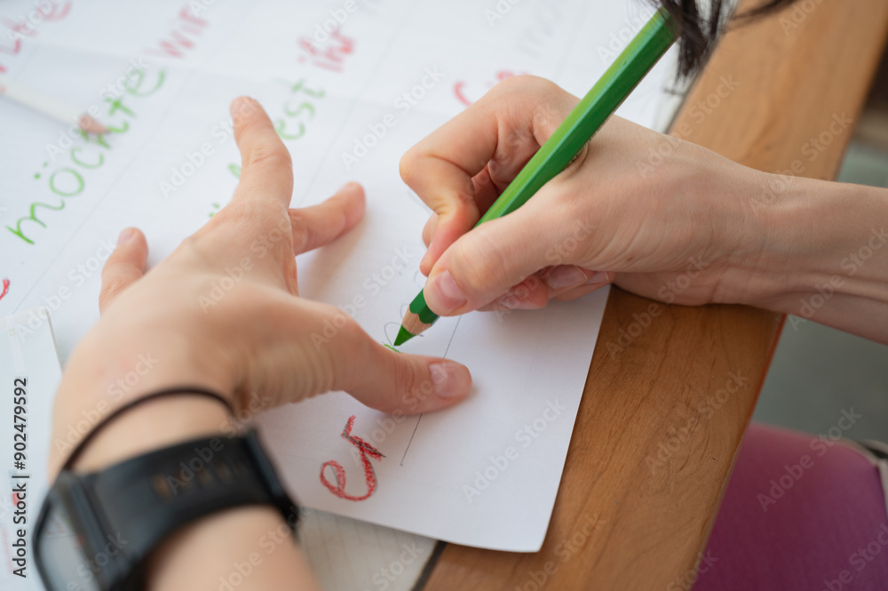 Woman hands writing with green pencil, drawing with pencil close up. German grammarly placate creating. Er translated on english as he. Woman hands writing with green pencil, drawing with pencil close up. German grammarly placate creating. Er translated on english as he.