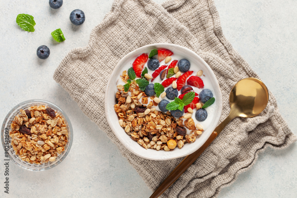 Homemade crispy granola, yogurt and berries in bowl on white background. Healthy breakfast. Top view Homemade crispy granola, yogurt and berries in bowl on white background. Healthy breakfast. Top view