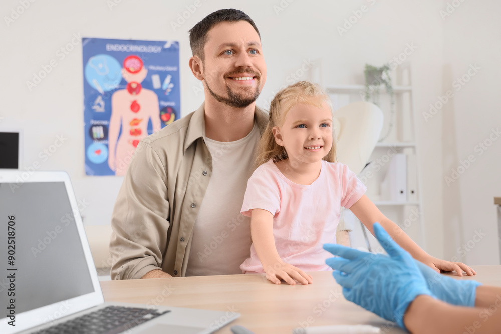 Little girl with her father visiting endocrinologist in clinic Little girl with her father visiting endocrinologist in clinic