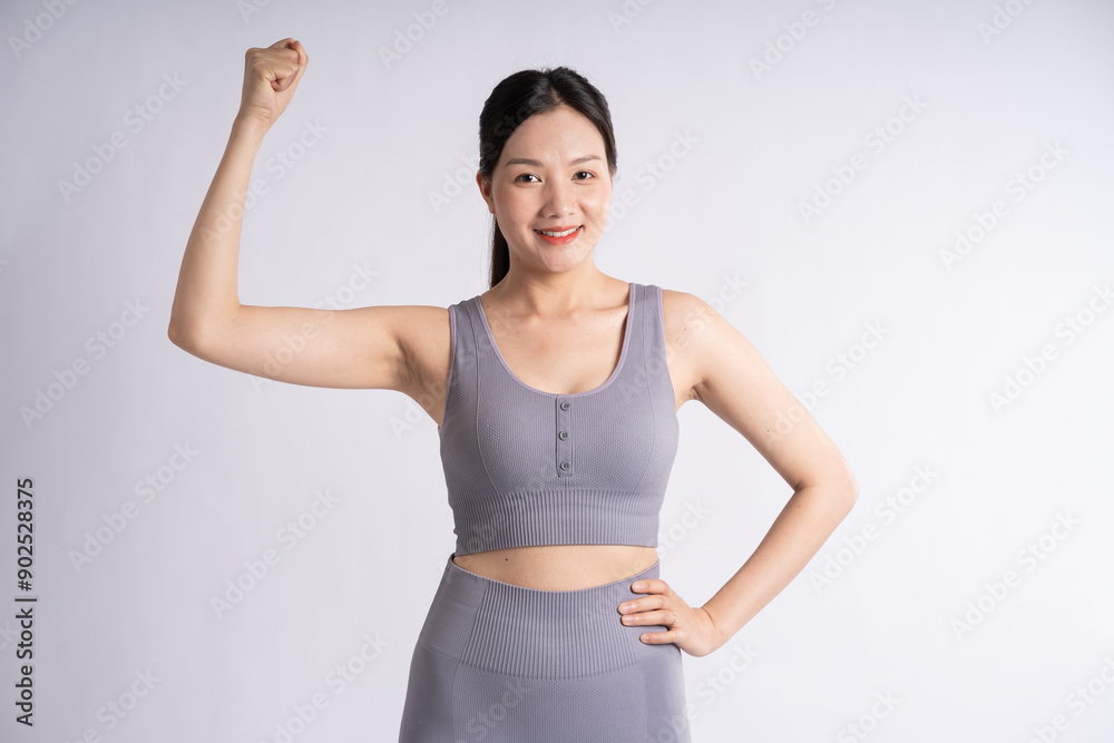 Portrait of Asian woman wearing sportswear, posing on white background Portrait of Asian woman wearing sportswear, posing on white background