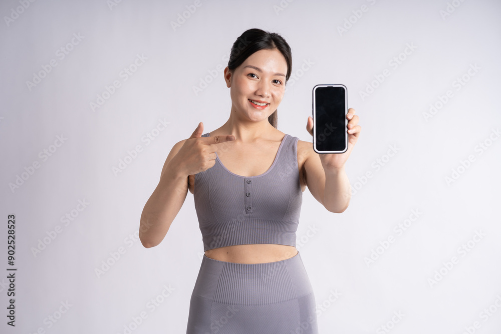 Portrait of Asian woman wearing sportswear, posing on white background Portrait of Asian woman wearing sportswear, posing on white background