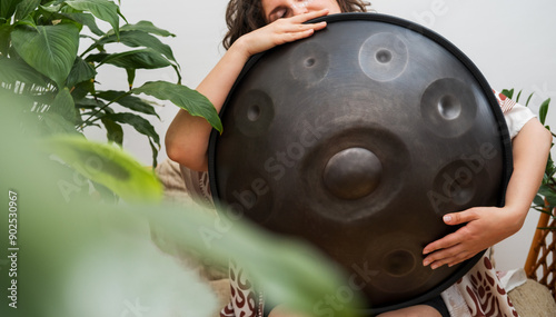 Woman holding hang drum close up photo