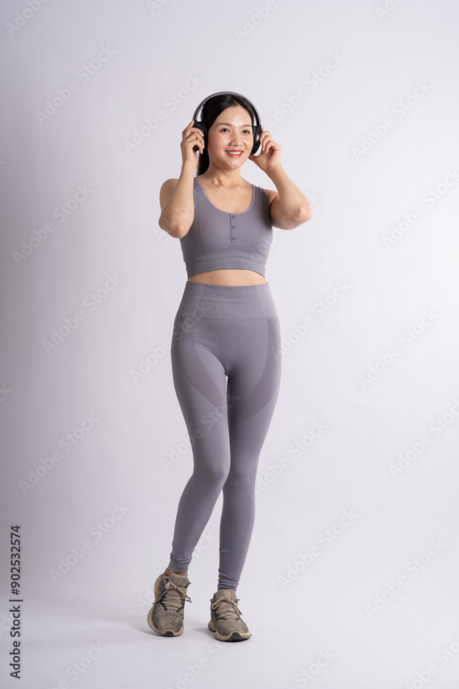 Portrait of Asian woman wearing sportswear, posing on white background. Portrait of Asian woman wearing sportswear, posing on white background.