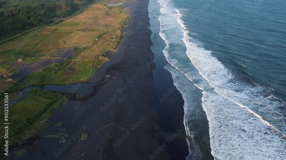 Aerial view of a beautiful beach landscape with black sand beaches and waves crashing on the coastline Aerial view of a beautiful beach landscape with black sand beaches and waves crashing on the coastline