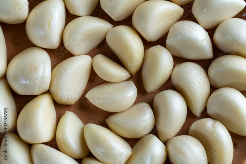 top view close shot of scattered garlic in wooden bowl