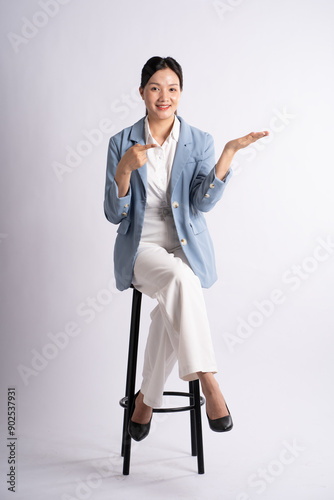 Portrait of young businesswoman posing on white background