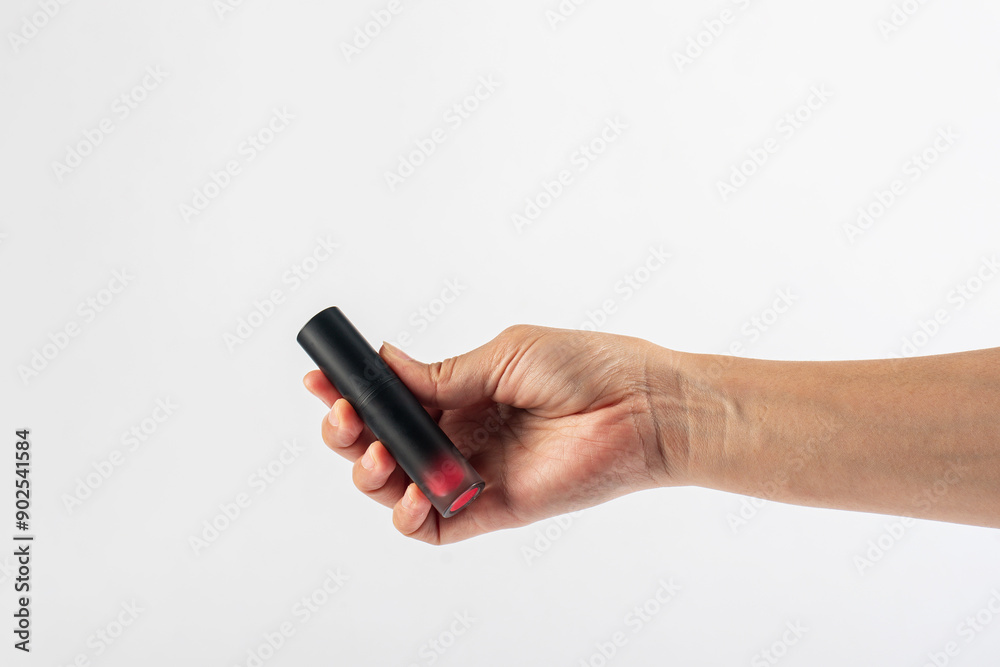 Fototapeta premium Close up of lip gloss in hand on white background.