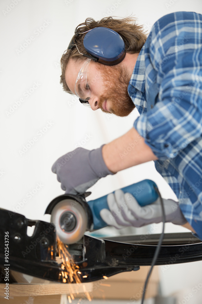 close up of mans hands working with a circular grindstone close up of mans hands working with a circular grindstone