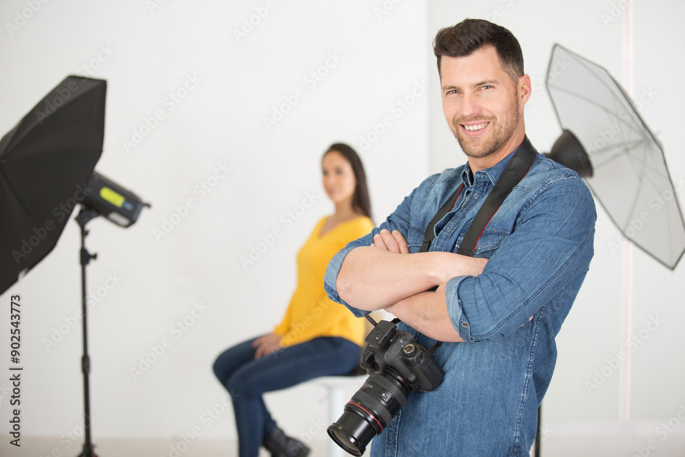 focused picture of male photographer with model at the background focused picture of male photographer with model at the background