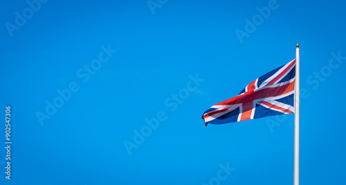 British Union Jack flag blowing in the wind on flag pole