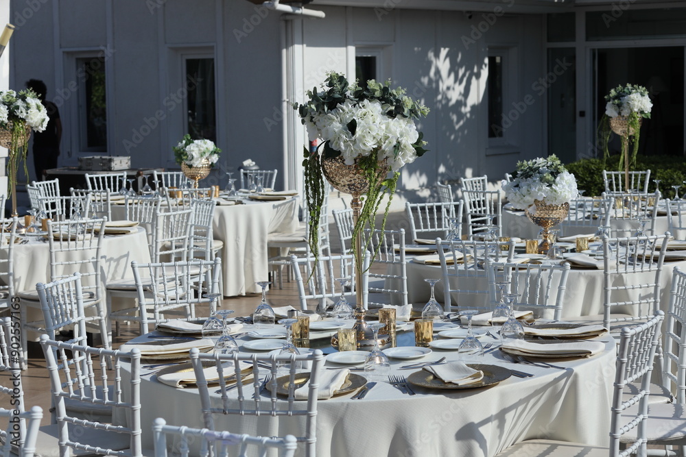 Elegant Outdoor Wedding Reception with White Chiavari Chairs and Floral Centerpieces