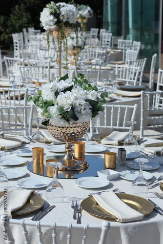 Elegant Outdoor Wedding Reception with White Chiavari Chairs and Floral Centerpieces