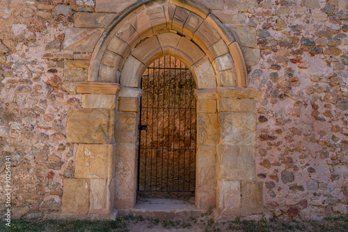 A rustic stone archway at Monasterio de San Juan de Duero in Soria, Spain. The medieval architecture and weathered stone walls reflect the monastery's rich history.