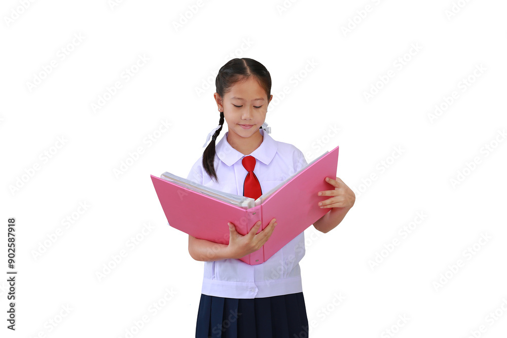Asian student girl in primary school uniform standing with holding open hard book isolated on white background. Image with Clipping path. Asian student girl in primary school uniform standing with holding open hard book isolated on white background. Image with Clipping path.