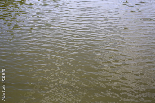 River canal flowing through with rippling water surface.