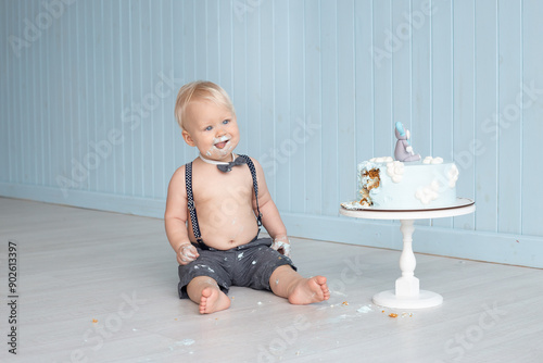 Baby experiencing first birthday cake smash celebration. First birthday milestone.