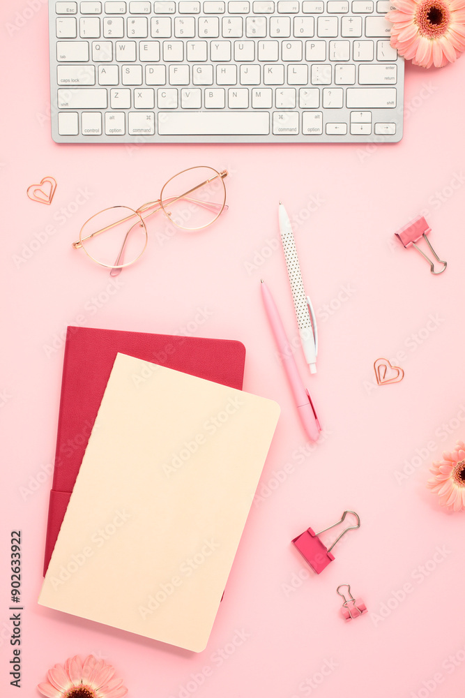 Office chic stylish workspace with keyboard, glasses and stationery on pink background. Perfect for modern professionals Office chic stylish workspace with keyboard, glasses and stationery on pink background. Perfect for modern professionals