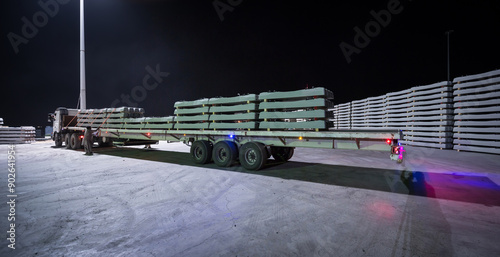 Railway Sleepers Stacked for Transportation at Night photo