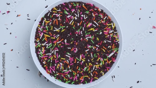 top view of chocolate sprinkles in spinning white plate