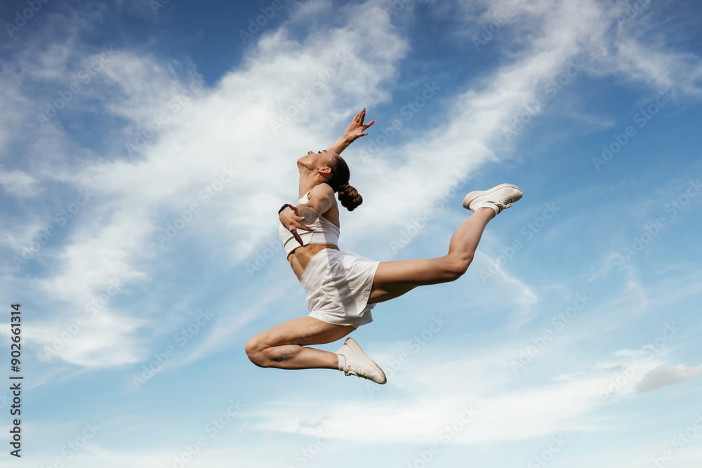 Beautiful sky at background. Young skinny fitness woman is outdoors Beautiful sky at background. Young skinny fitness woman is outdoors