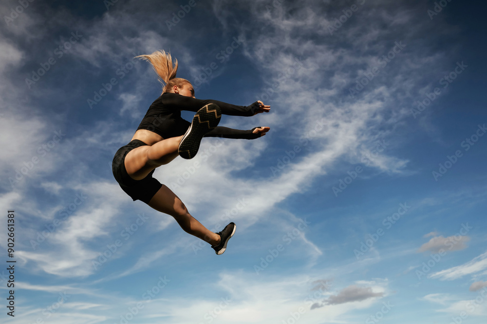 Crazy tricks in the air. Beautiful fitness woman in sport clothes is outdoors Crazy tricks in the air. Beautiful fitness woman in sport clothes is outdoors