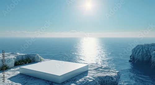 A white square is on a rocky shoreline next to the ocean