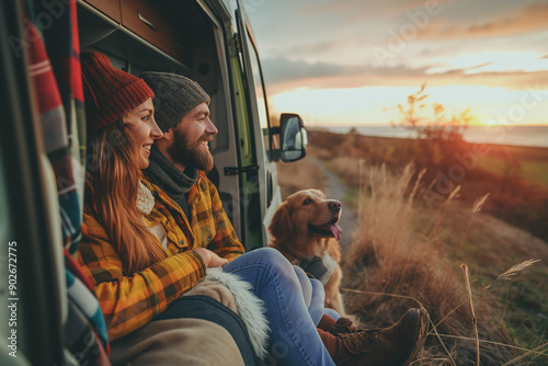 Couple and dog enjoy they vacation with beautiful landscape view on camper van. Road trip, holiday