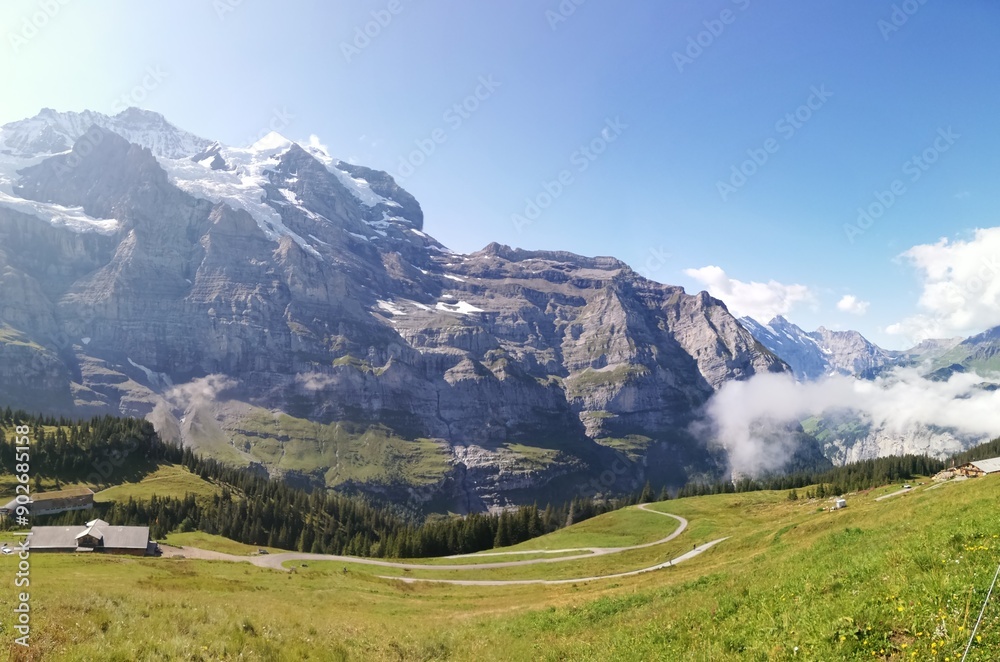 Mountain panoramic view with road serpentine and rural hut on sunny day Mountain panoramic view with road serpentine and rural hut on sunny day