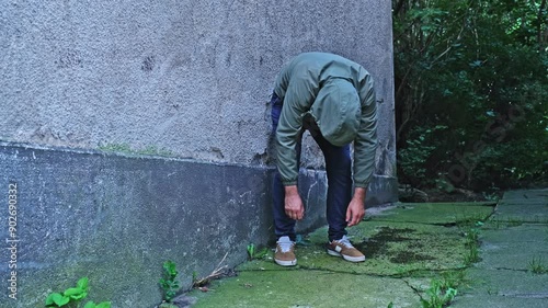 Fenantyl Drug Addict Junkie under Influence of Psychoactive Substance Narcotic Standing in Folded Zombie Pose in Dangerous Shabby Neighbourhood Alley
