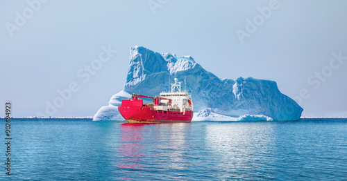 Arctic Ship leaving Tasiilaq after having unloaded at the docks in the harbour - Tasiilaq, Greenland photo